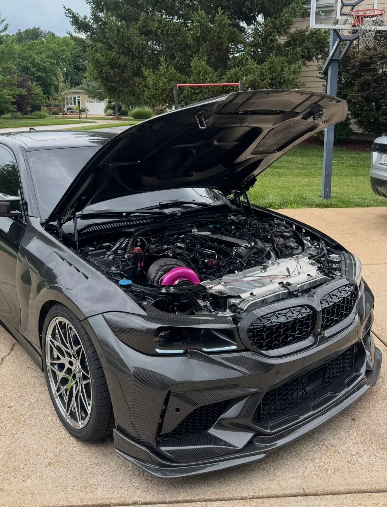 M340i with the hood up, turbo kit visible