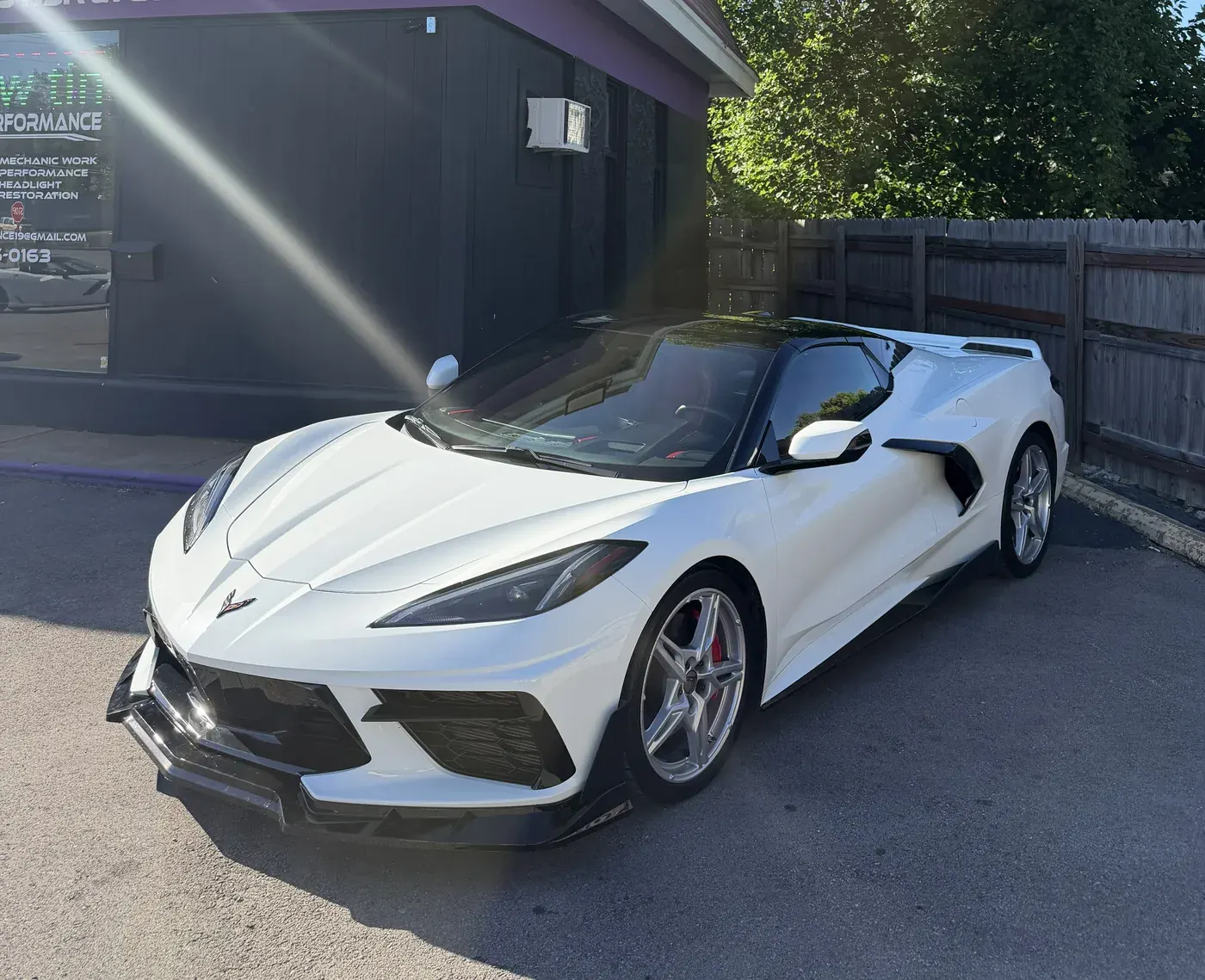 White Corvette with black accents outside the shop