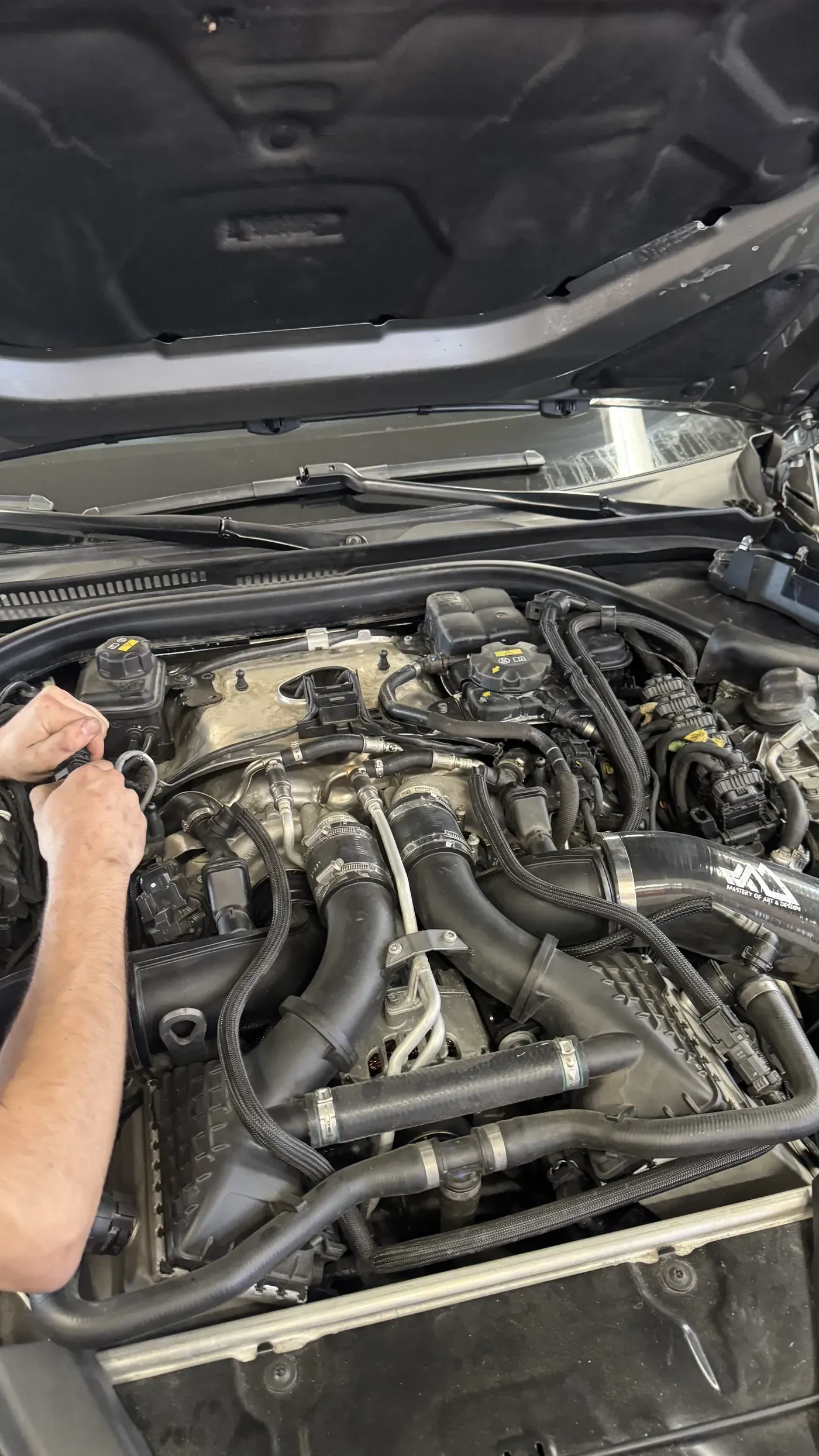 Technician working in an engine bay