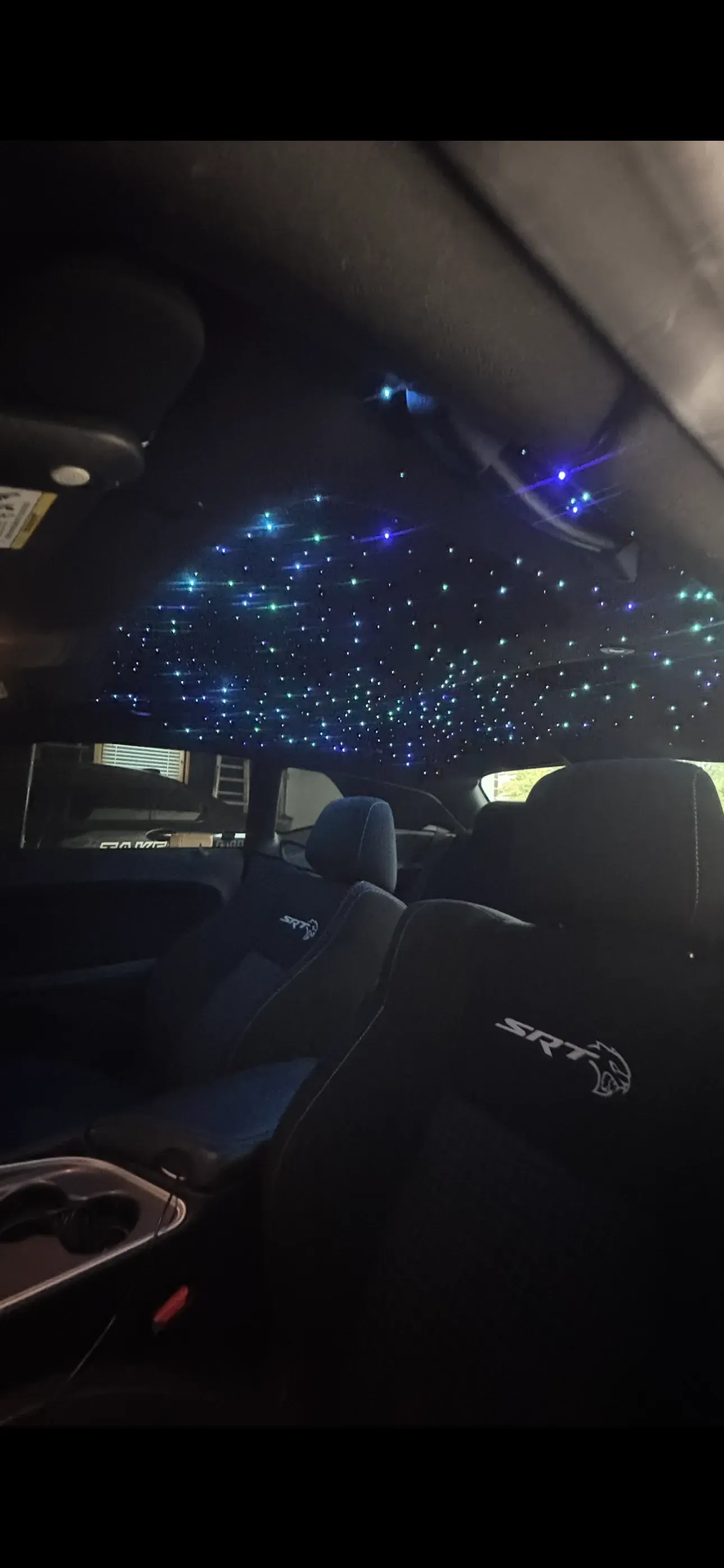 Blue starlight headliner in a dark cabin