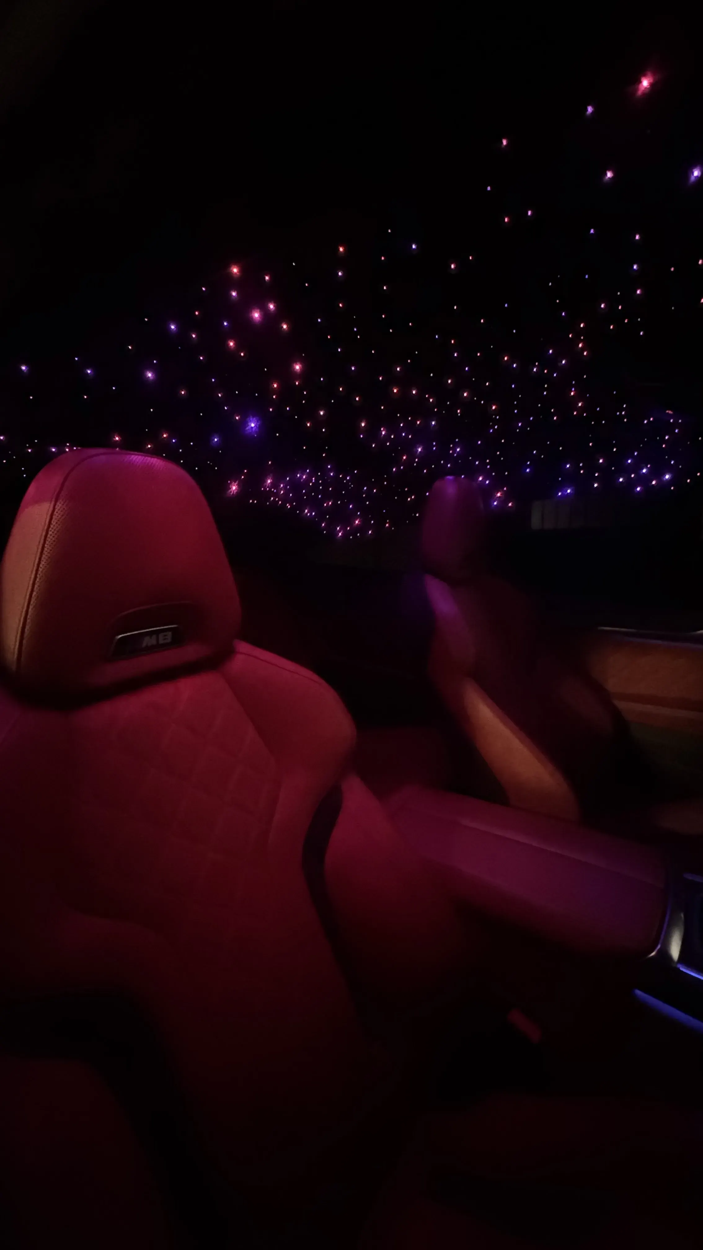 Pink starlight headliner above red seats