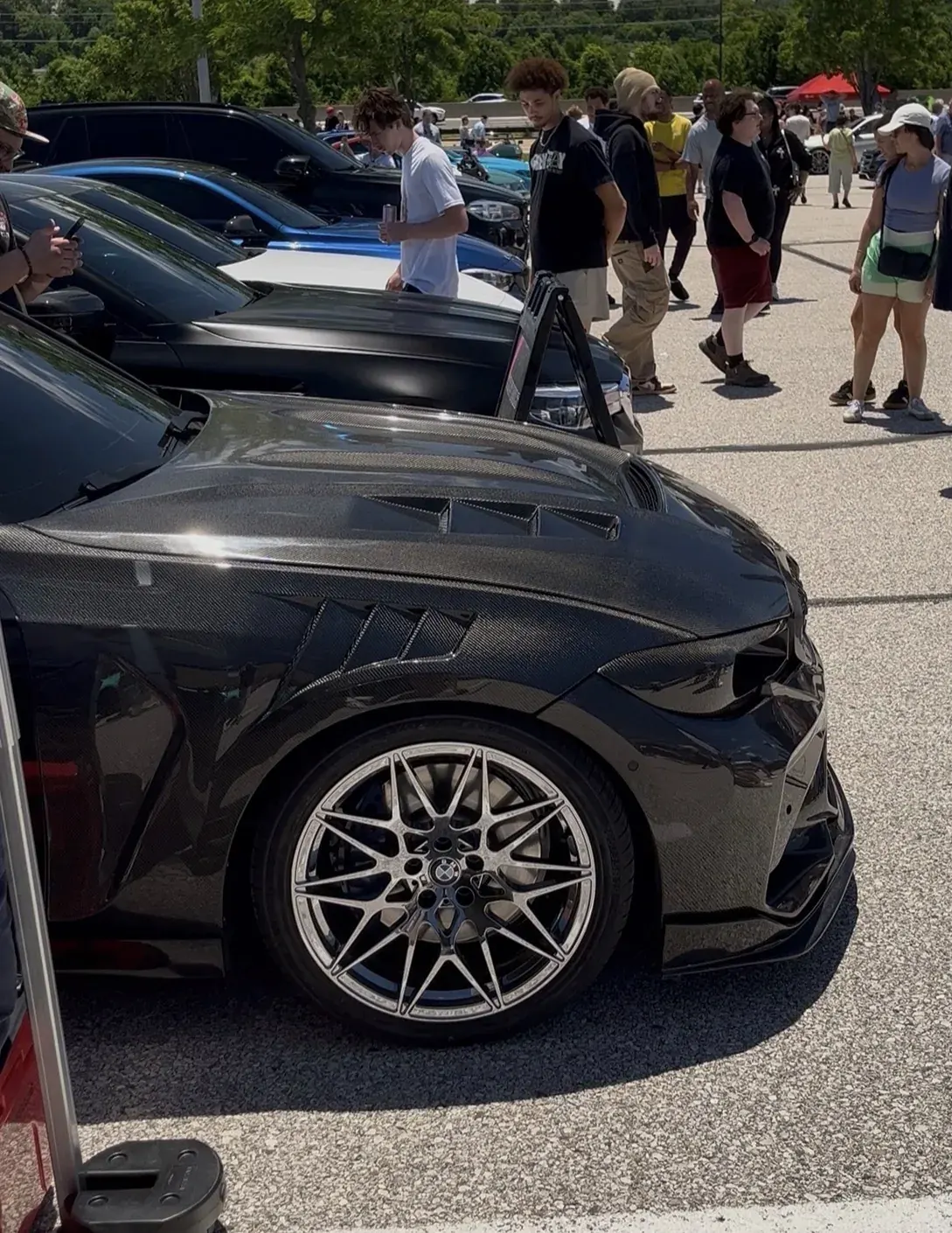 Black BMW M3 wheel and tire at a meet