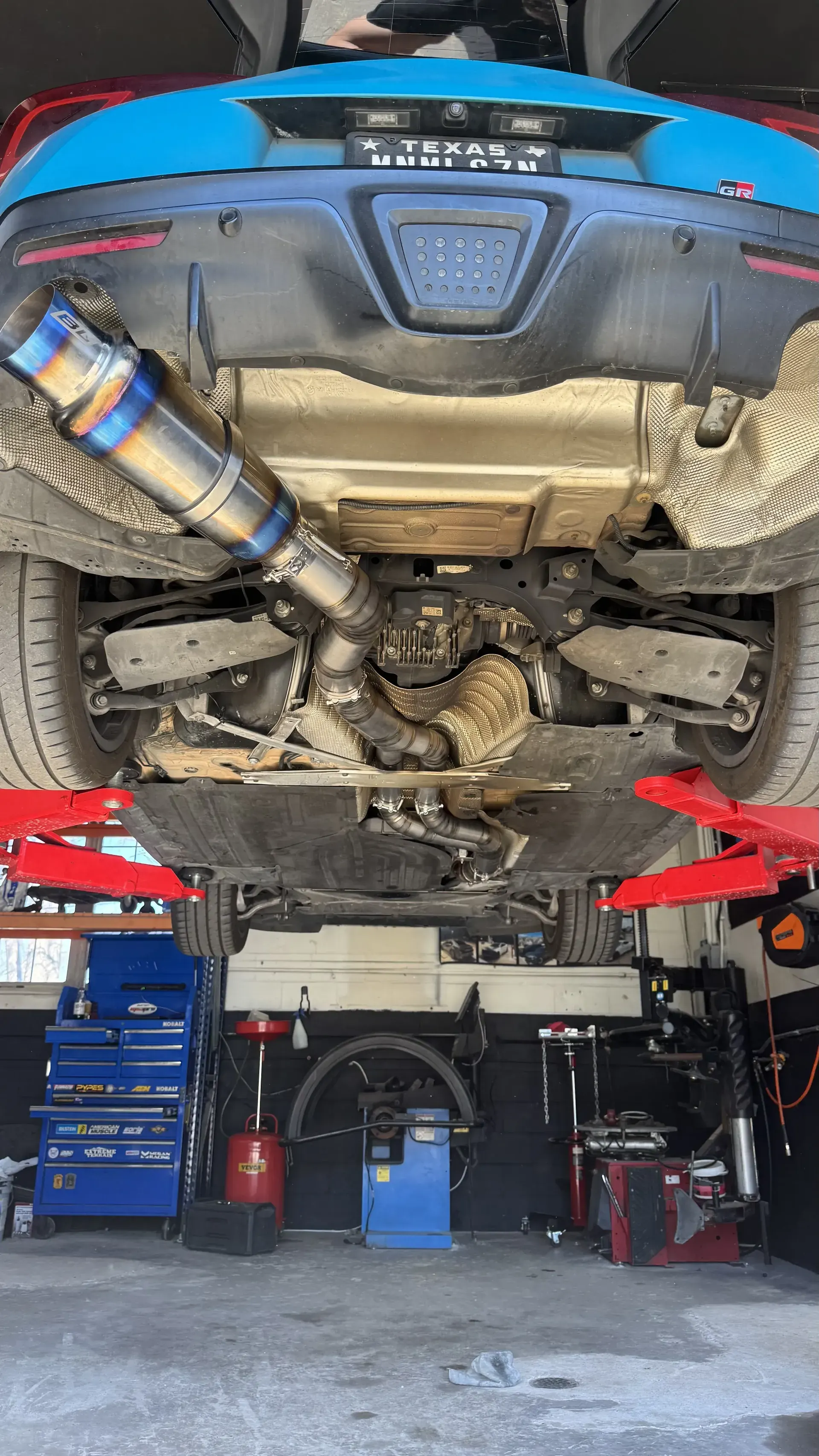Titanium exhaust under a car on the lift