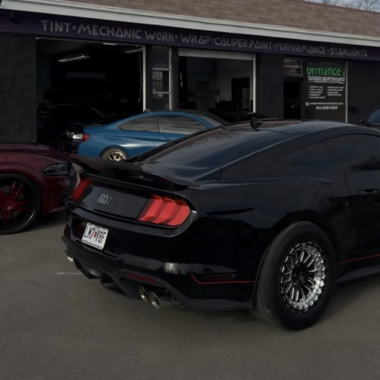 Black Mustang with new wheels and tires