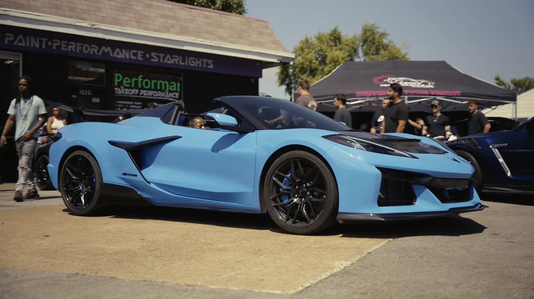 Blue Corvette at a Takeoff meet in front of the shop and the Takeoff tent