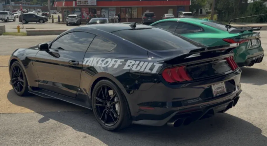 Black Mustang with Takeoff Built lettering, rear view