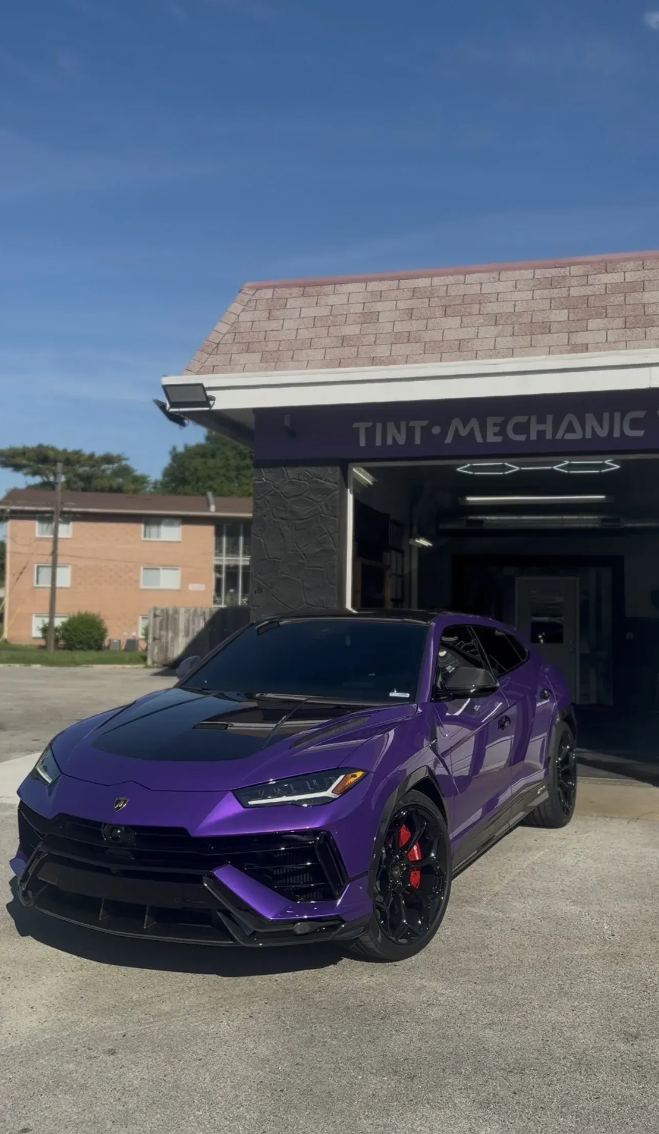 Purple Lamborghini Urus in front of the Takeoff shop